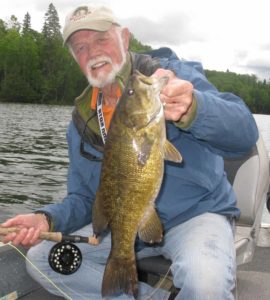 Dan Johnson on a Minnesota lake with a large smallmouth