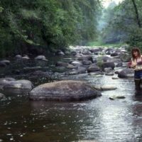 Angler probes a hot low-water smallmouth bass spot.