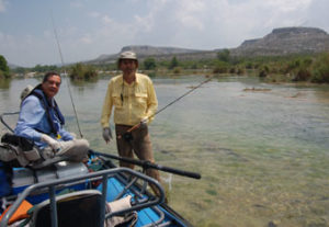 Two anglers fishing the Devil's River in Texas via raft